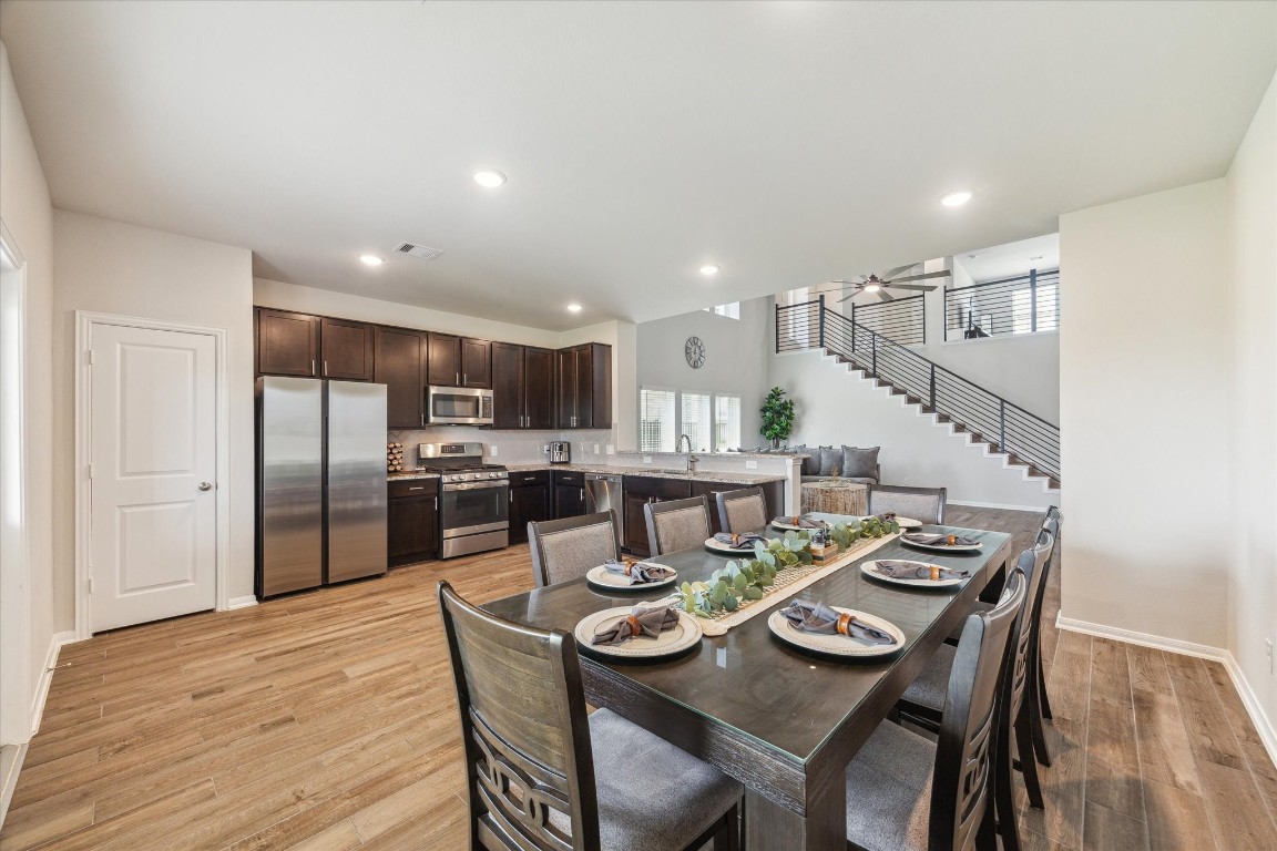 1523 Alpine Drive Rosharon, TX 77583 - Photo 5 of 25 a kitchen with stainless steel appliances kitchen island granite countertop a dining table and chairs