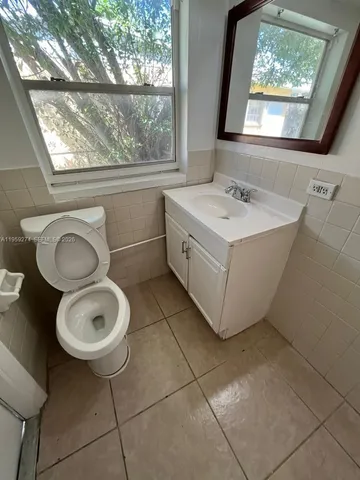 a bathroom with a sink mirror vanity and toilet
