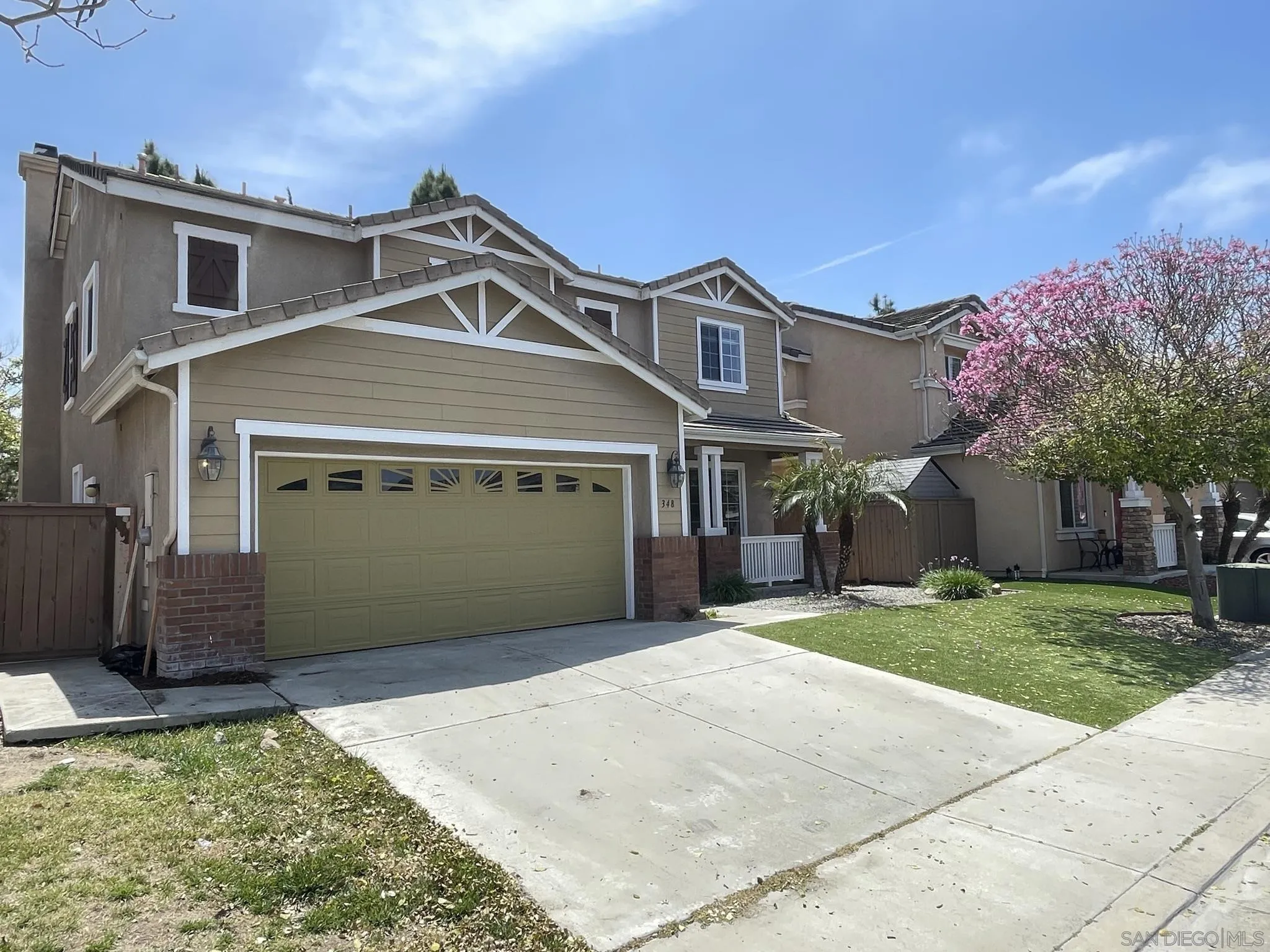 348 Monte Vista Way Oceanside, CA 92057 - Photo 1 of 20 a front view of a house with a yard and garage
