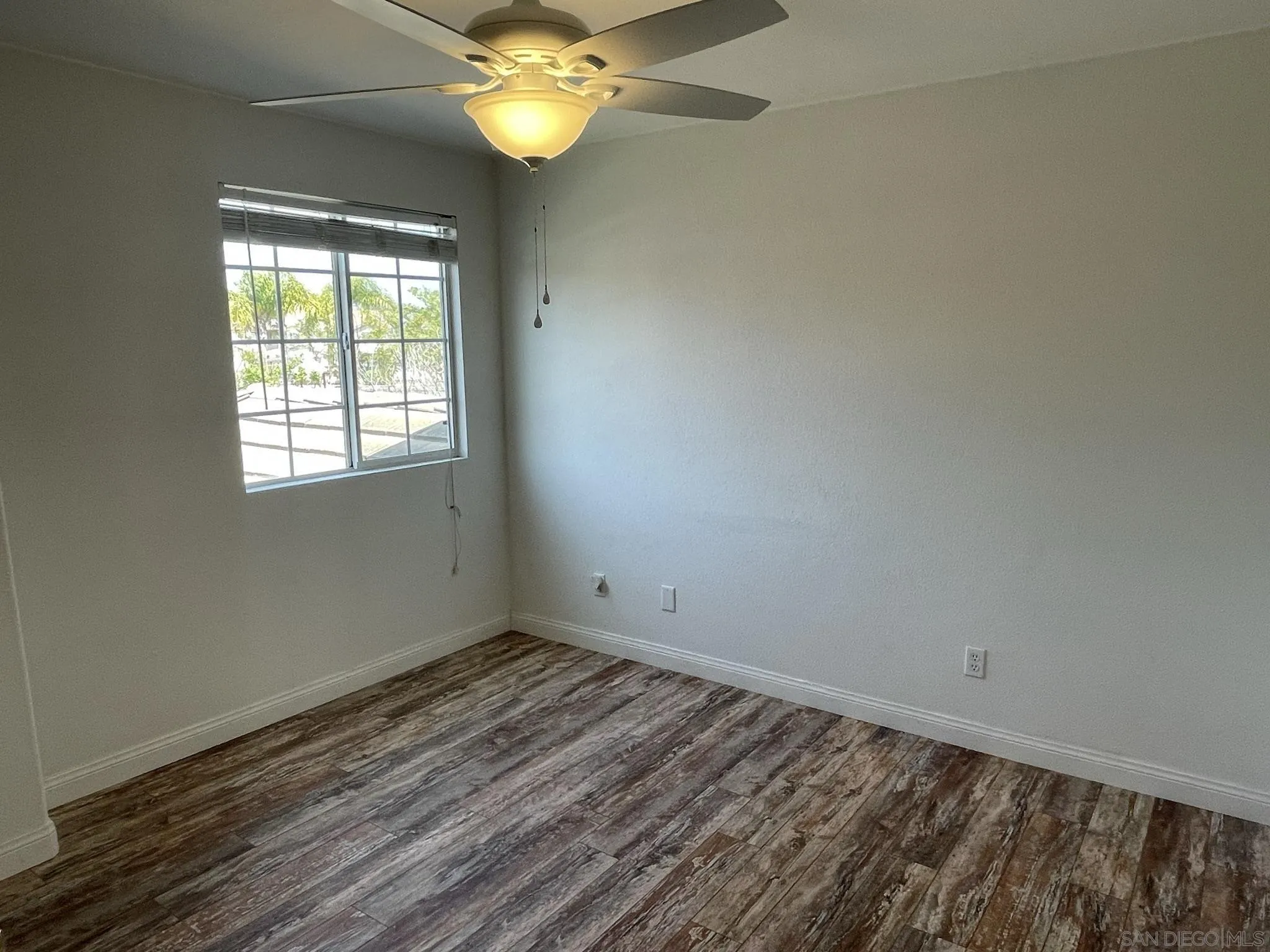 348 Monte Vista Way Oceanside, CA 92057 - Photo 13 of 20 an empty room with a chandelier fan and windows