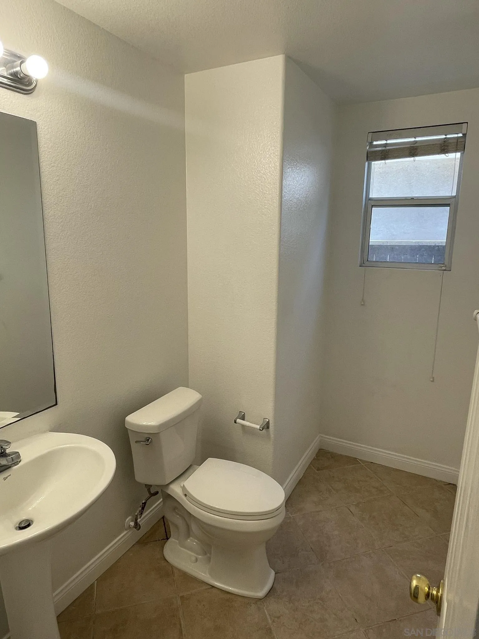 348 Monte Vista Way Oceanside, CA 92057 - Photo 18 of 20 a white toilet sitting next to a bathroom sink