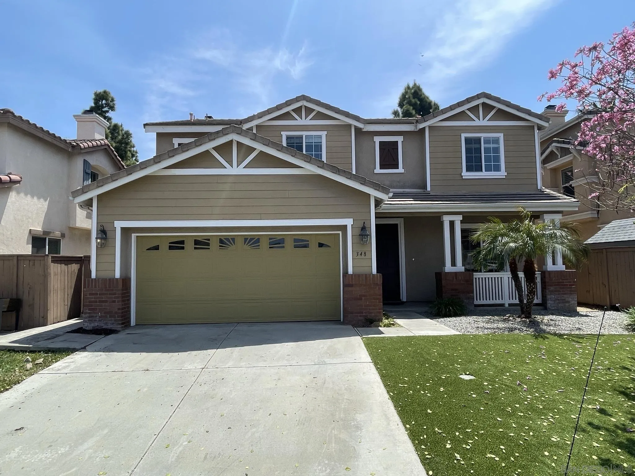 348 Monte Vista Way Oceanside, CA 92057 - Photo 3 of 20 a front view of a house with a yard and garage