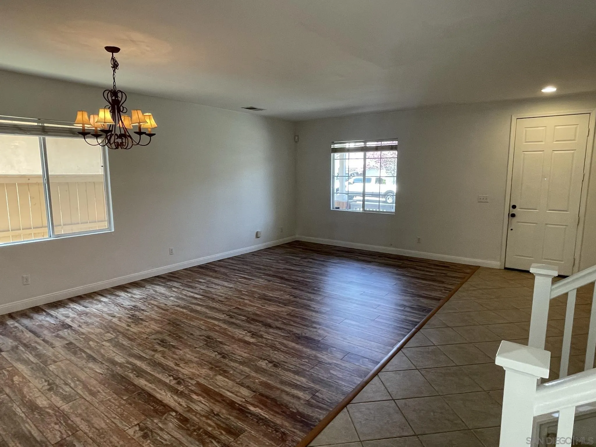 348 Monte Vista Way Oceanside, CA 92057 - Photo 7 of 20 an empty room with wooden floor chandelier fan and window