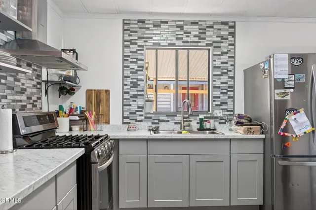 a kitchen with a sink stove and cabinets