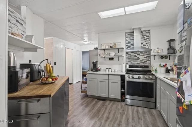 a kitchen with stainless steel appliances granite countertop a stove and a sink