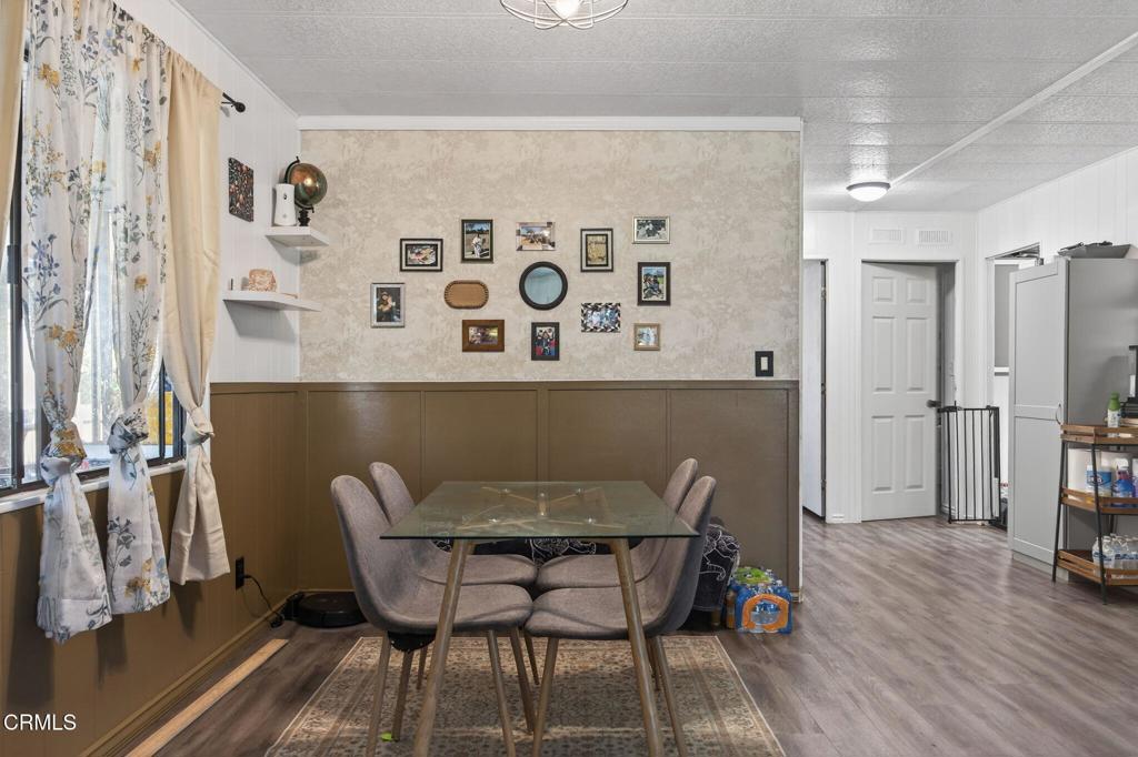 2408 Apple Lane, Unit 154 Oxnard, CA 93036 - Photo 18 of 46 a dining room with furniture and wooden floor