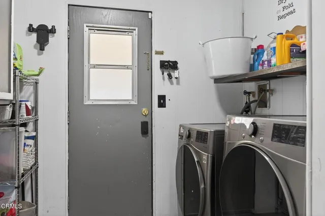 a utility room with dryer washer and a window