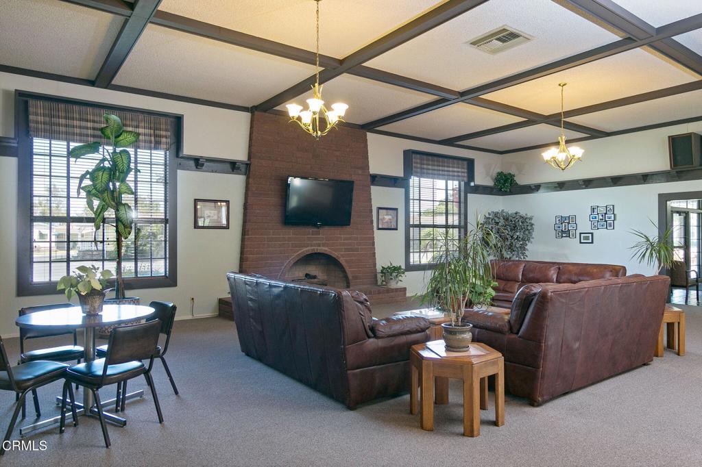 2408 Apple Lane, Unit 154 Oxnard, CA 93036 - Photo 41 of 46 a living room with furniture a flat screen tv and a large window