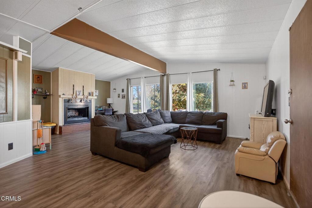 2408 Apple Lane, Unit 154 Oxnard, CA 93036 - Photo 8 of 46 a living room with furniture kitchen view and a wooden floor