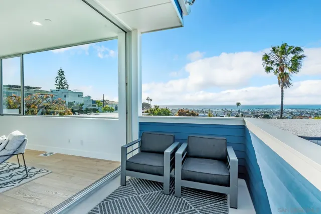 a view of sitting area in balcony with furniture