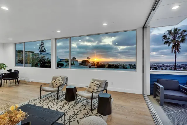 a living room with patio furniture and a floor to ceiling window