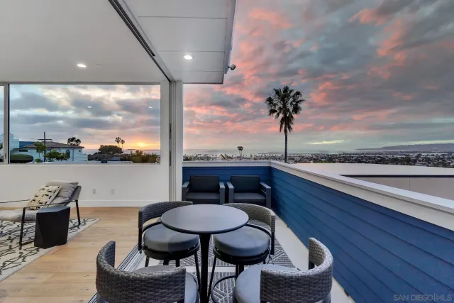 a view of a balcony with furniture and a floor to ceiling window