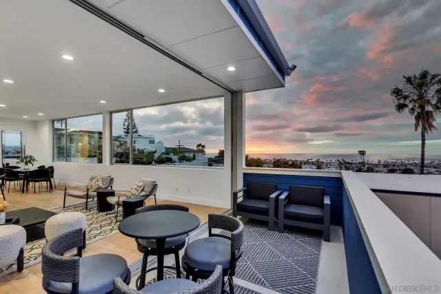 a living room with furniture and a floor to ceiling window
