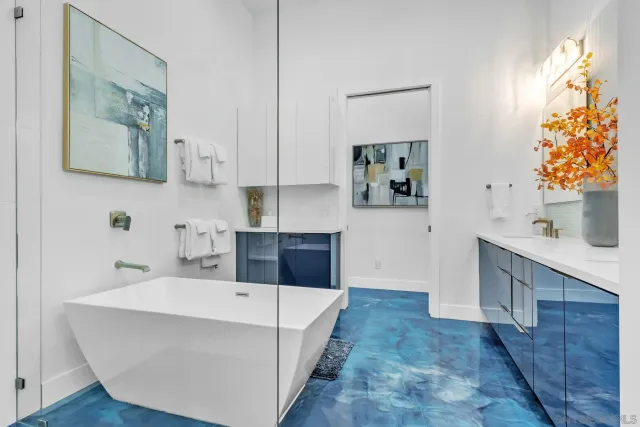 a spacious bathroom with a tub a mirror and shower