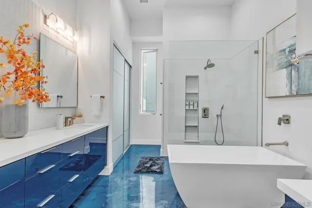 a bedroom with a bed and a flat tv screen on the dresser