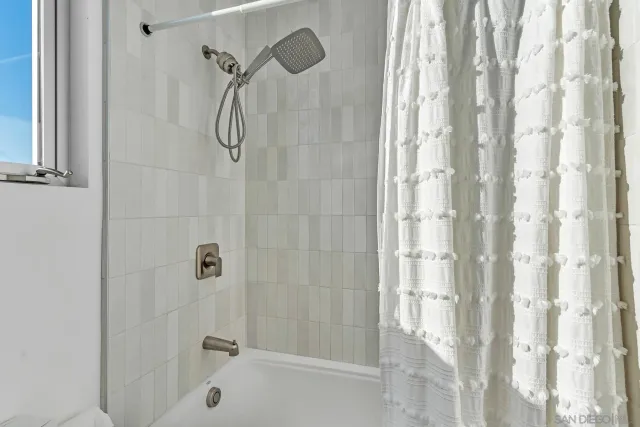 a living room with furniture and a painting on the wall