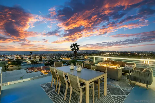 a view of a terrace with dining table and chairs