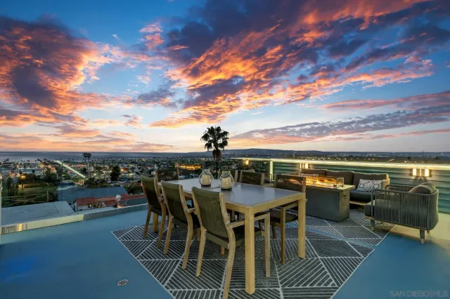 a view of a kitchen with wooden cabinets and stainless steel appliances