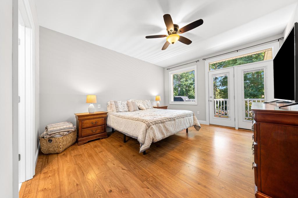 217 Maret Road Townville, SC 29689 - Photo 16 of 35 Hardwood floors and a private balcony enhance this inviting, naturally illuminated primary bedroom.