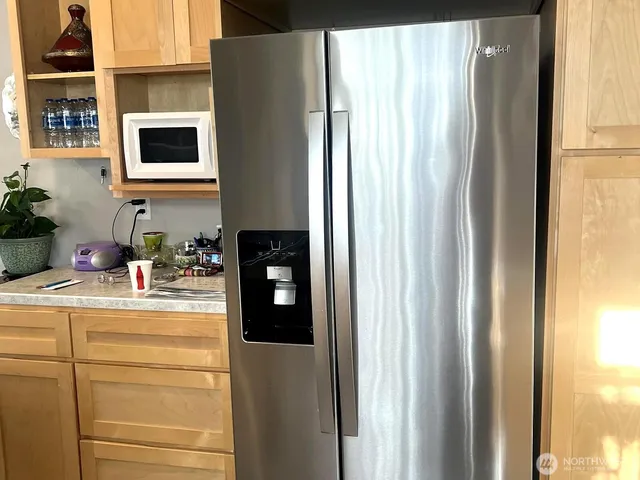 a kitchen with a refrigerator and a sink