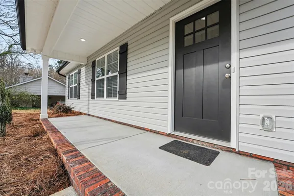 a view of a house with a door and wooden walls