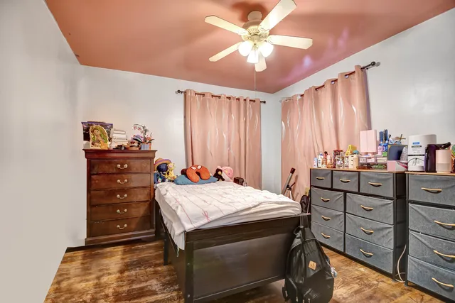 a bedroom with a bed and a dresser