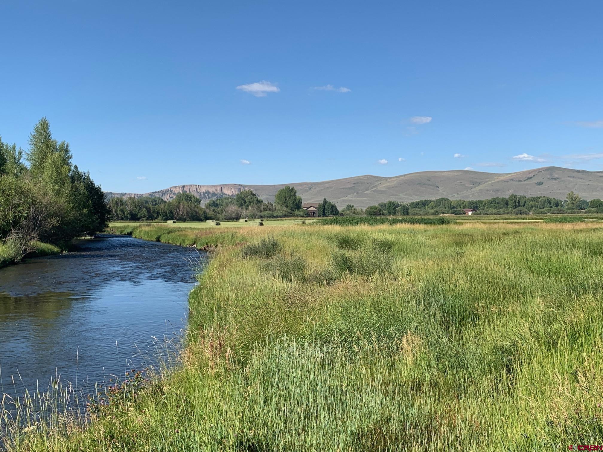 607 County Road 730 Gunnison, CO 81230 - Photo 2 of 35 a view of a lake with houses in the background