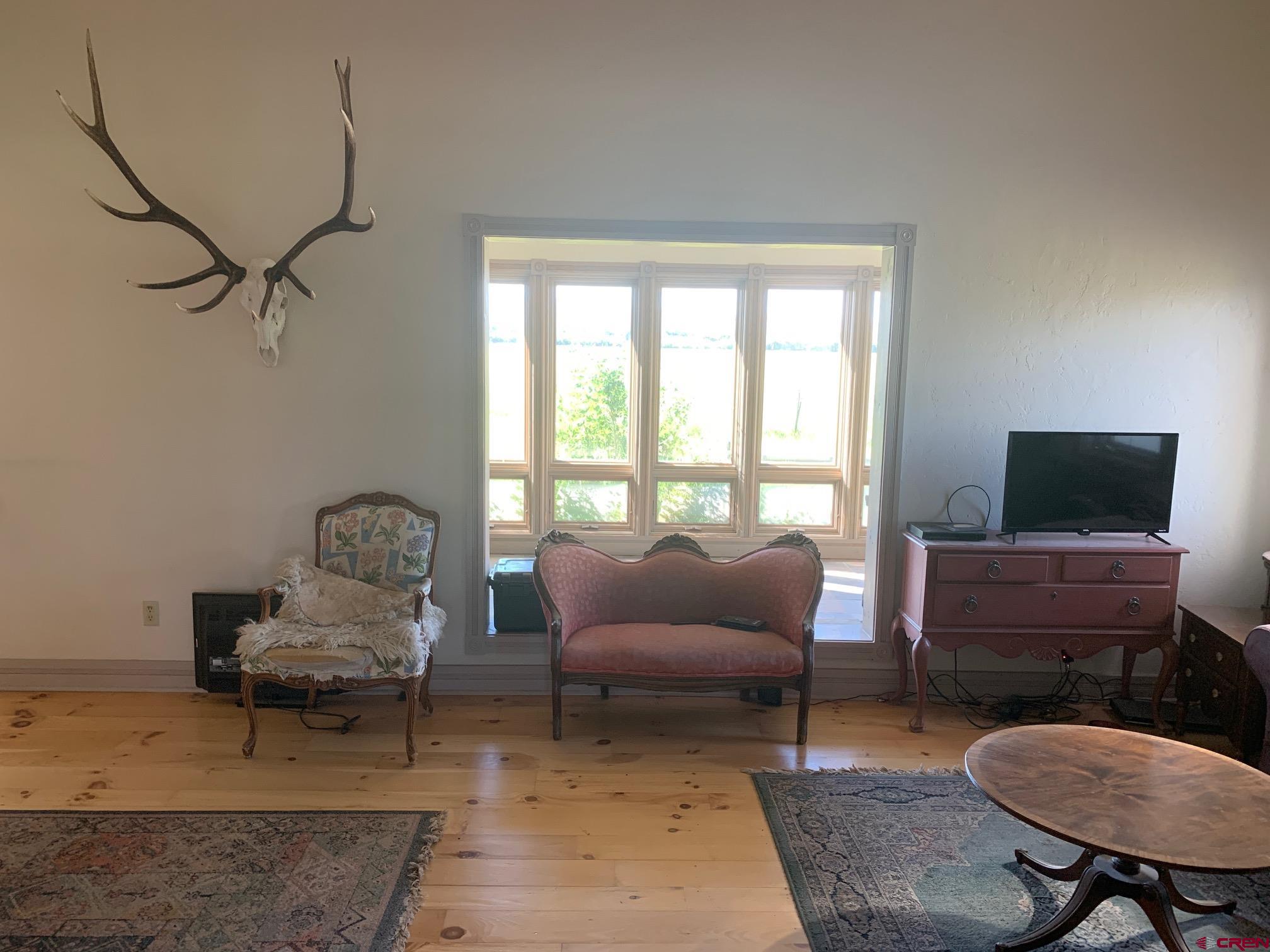 607 County Road 730 Gunnison, CO 81230 - Photo 21 of 35 a living room with furniture and a flat screen tv