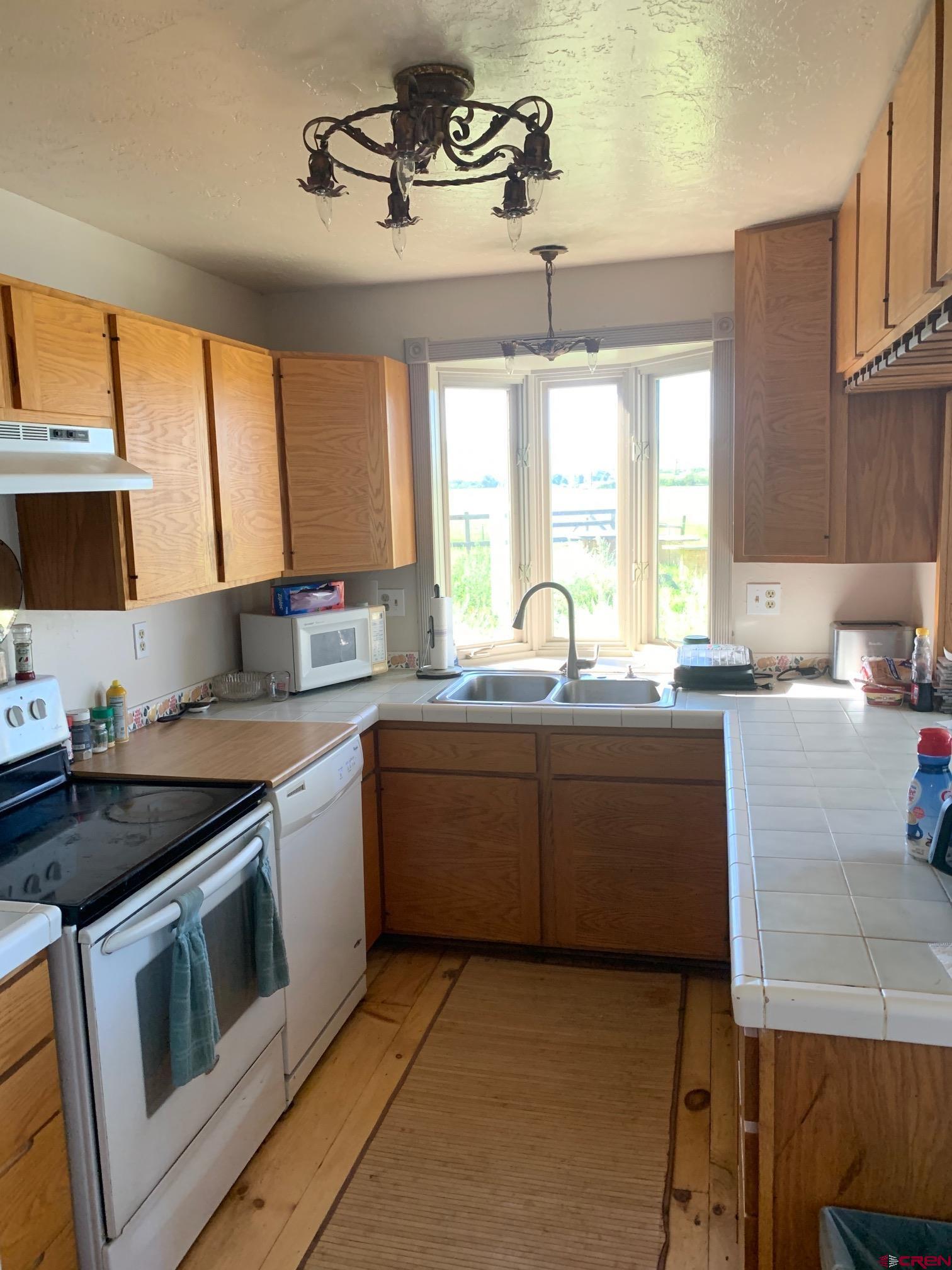 607 County Road 730 Gunnison, CO 81230 - Photo 24 of 35 a kitchen with a sink stove and microwave