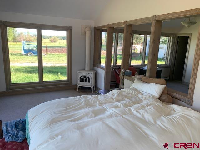 607 County Road 730 Gunnison, CO 81230 - Photo 25 of 35 a spacious bedroom with a large bed and a large window