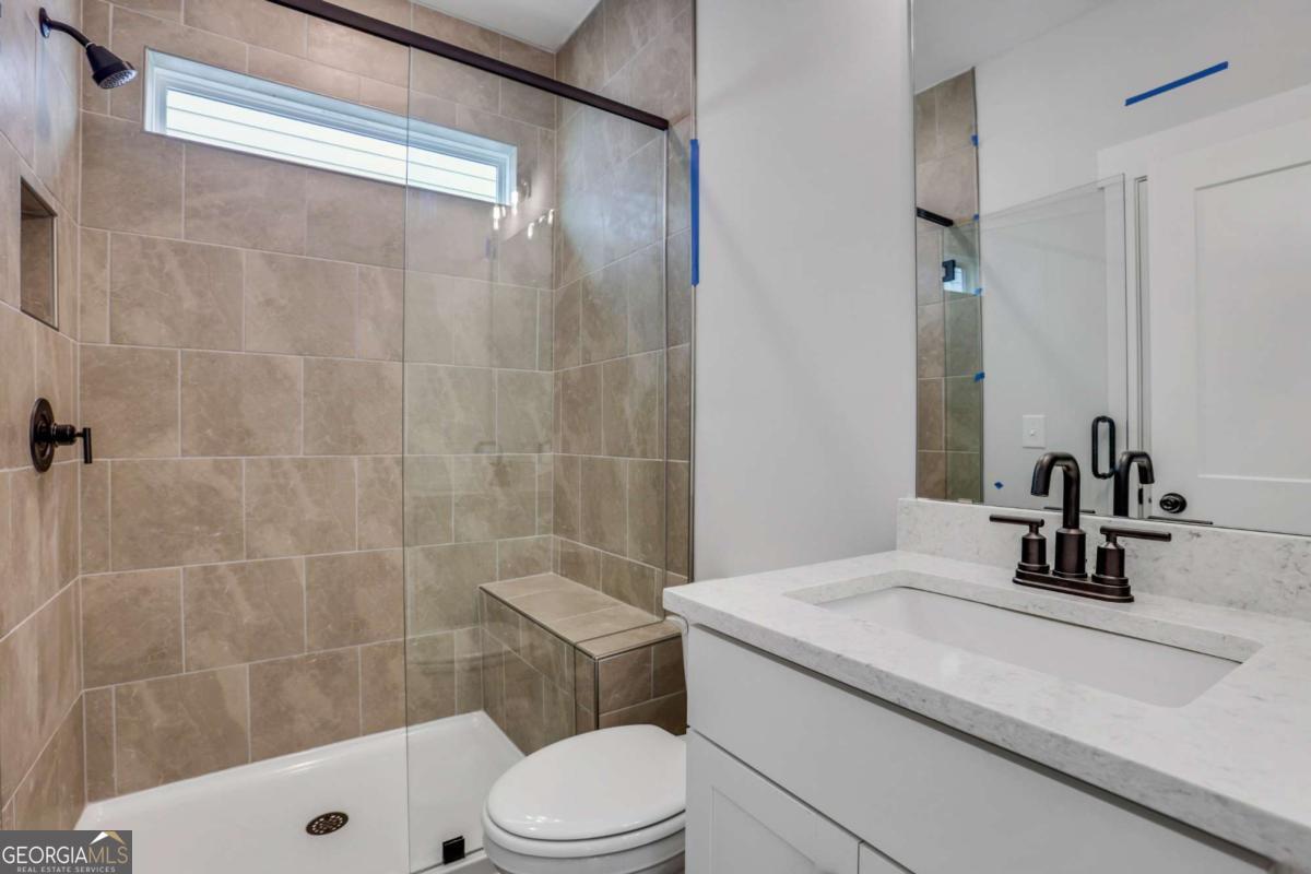 4250 Mary Ruth Way Loganville, GA 30052 - Photo 22 of 50 a bathroom with a sink a toilet and shower
