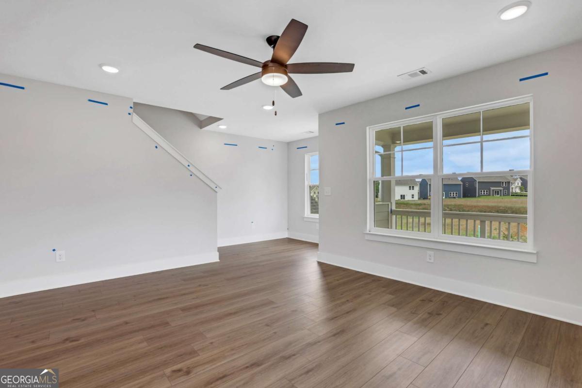 4250 Mary Ruth Way Loganville, GA 30052 - Photo 25 of 50 a view of an empty room with wooden floor and a window