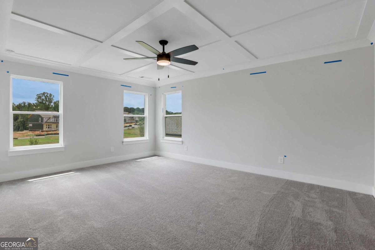 4250 Mary Ruth Way Loganville, GA 30052 - Photo 33 of 50 en empty room with windows and ceiling fan