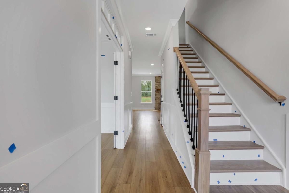 4250 Mary Ruth Way Loganville, GA 30052 - Photo 4 of 50 a view of a hallway with wooden floor and entryway