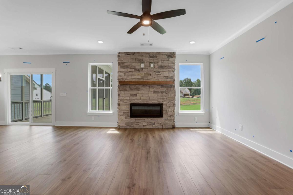 4250 Mary Ruth Way Loganville, GA 30052 - Photo 8 of 50 a view of an empty room with wooden floor fireplace and a window