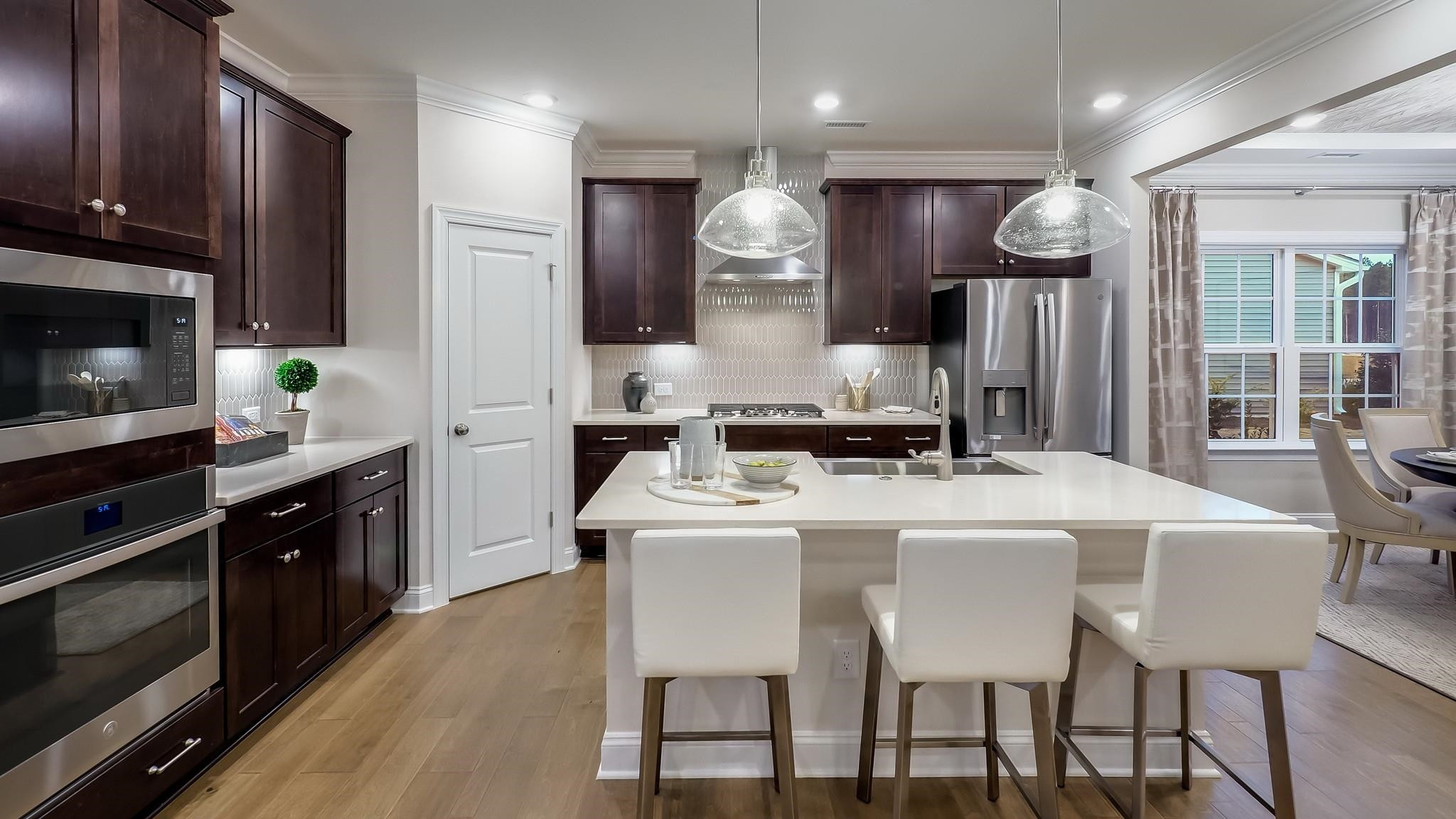 524 Tanner Lk Lane Raleigh, NC 27610 - Photo 17 of 35 a kitchen with a dining table chairs and refrigerator
