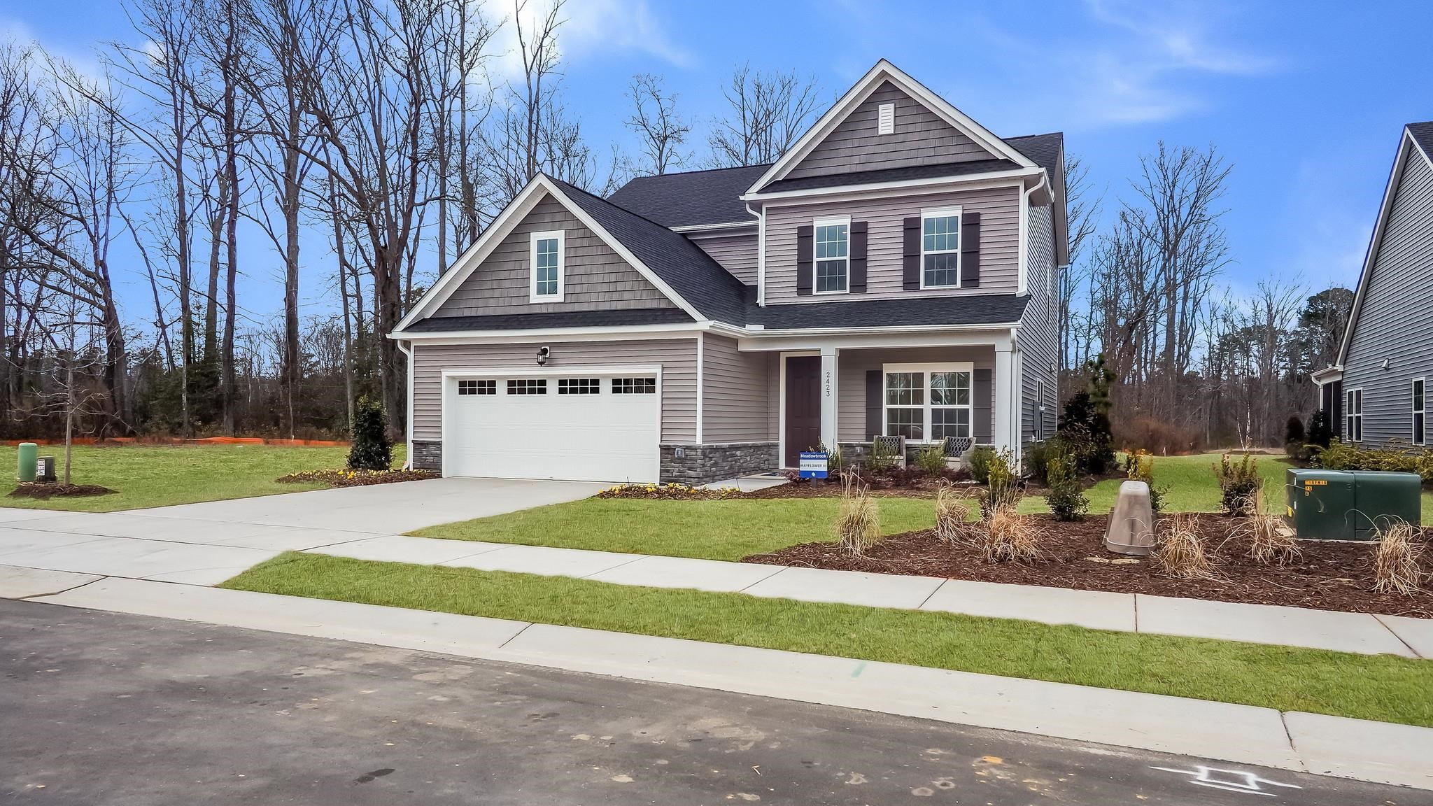 524 Tanner Lk Lane Raleigh, NC 27610 - Photo 4 of 35 a front view of a house with a yard and garage