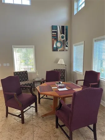 a dining room with furniture and window
