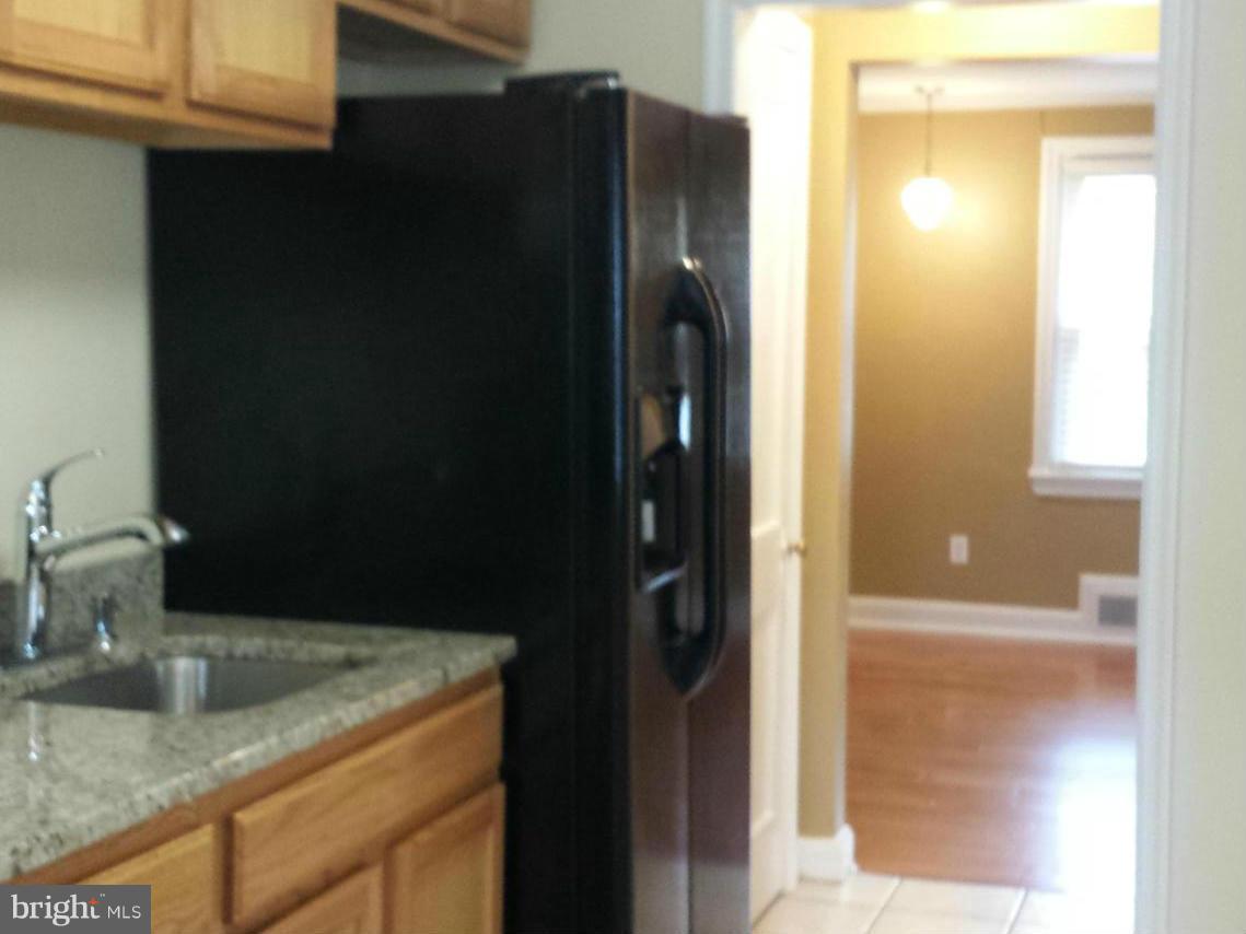 5115 Sunset Road Baltimore, MD 21215 - Photo 12 of 24 a bathroom with a granite countertop sink and a mirror