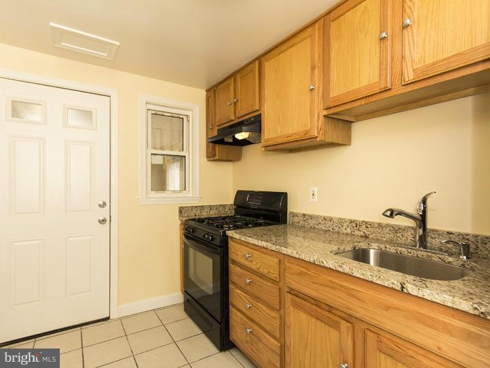 5115 Sunset Road Baltimore, MD 21215 - Photo 13 of 24 a kitchen with stainless steel appliances granite countertop a sink stove and cabinets