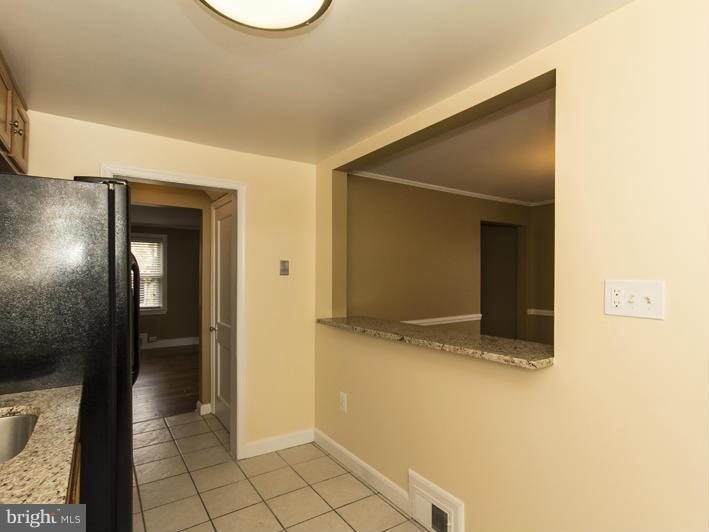 5115 Sunset Road Baltimore, MD 21215 - Photo 14 of 24 a view of a livingroom with wooden floor and a bathroom