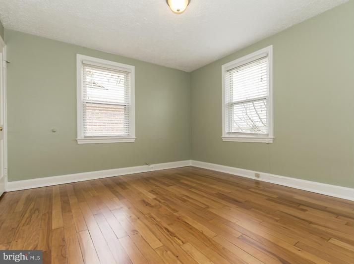 5115 Sunset Road Baltimore, MD 21215 - Photo 19 of 24 a view of an empty room with wooden floor and a window