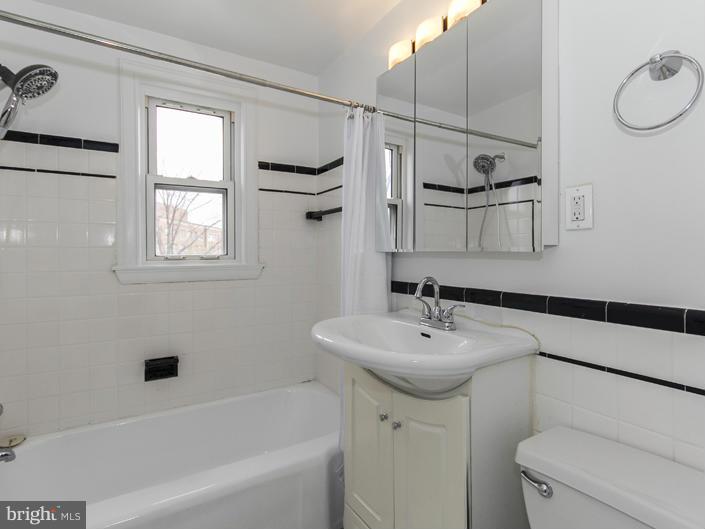 5115 Sunset Road Baltimore, MD 21215 - Photo 20 of 24 a bathroom with a sink a toilet and shower