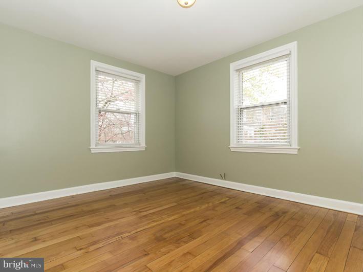 5115 Sunset Road Baltimore, MD 21215 - Photo 21 of 24 a view of a room with wooden floor and windows