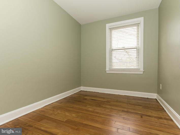 5115 Sunset Road Baltimore, MD 21215 - Photo 23 of 24 an empty room with wooden floor and a window