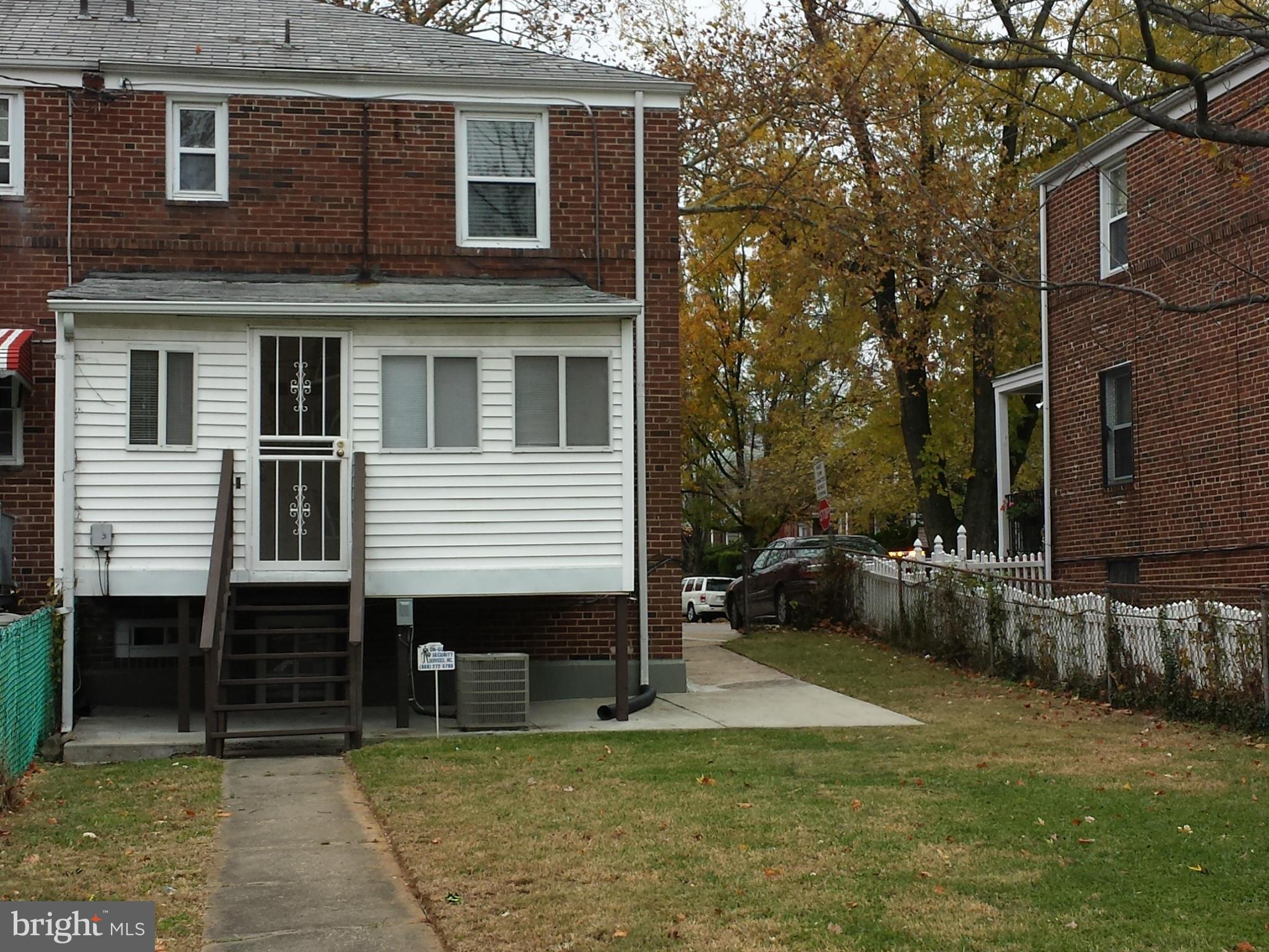 5115 Sunset Road Baltimore, MD 21215 - Photo 24 of 24 a backyard of a house with yard and glass windows