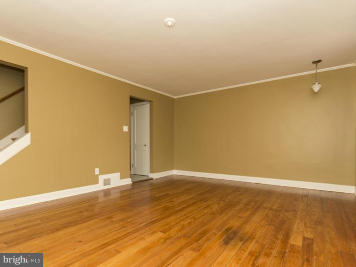 5115 Sunset Road Baltimore, MD 21215 - Photo 4 of 24 a view of a room with wooden floor and brick wall
