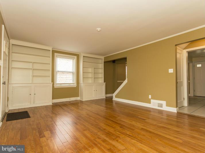 5115 Sunset Road Baltimore, MD 21215 - Photo 5 of 24 wooden floor in an empty room with a window