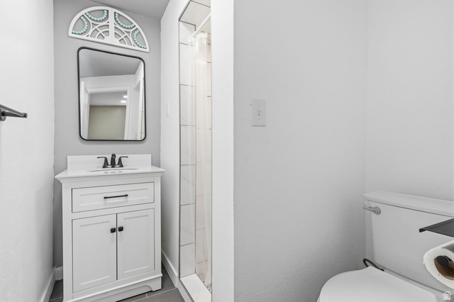 2693 Teal Way Sandy, UT 84093 - Photo 38 of 50 Contemporary bathroom featuring a white vanity with integrated sink, matte black faucet, and a rectangular framed mirror
