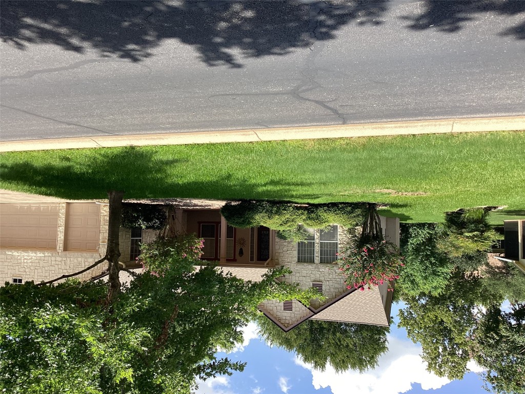 128 Crystal Springs Drive Georgetown, TX 78633 - Photo 1 of 7 a view of a house with a yard and a patio
